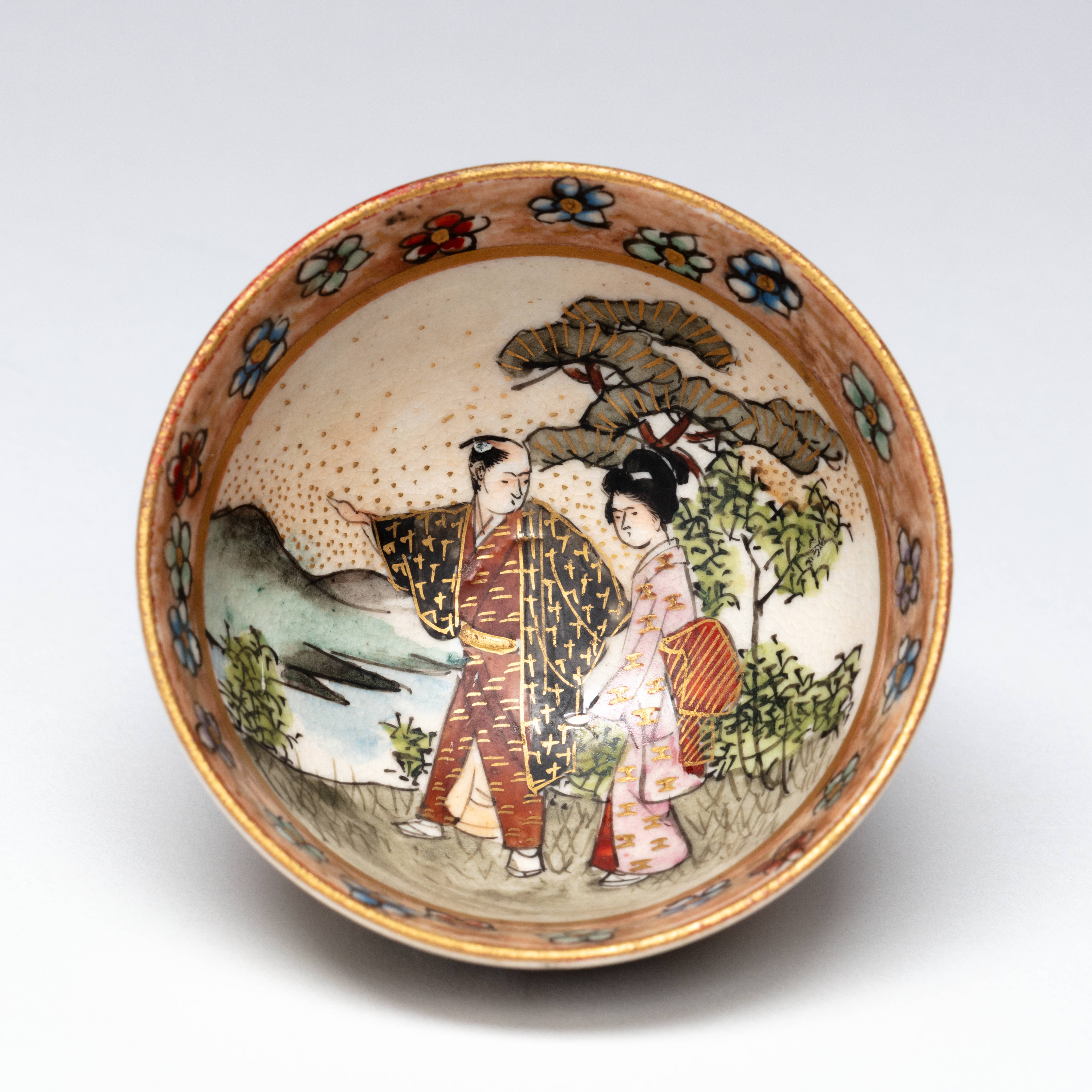 Sake cup with decoration of couple in a landscape, Kinkōzan Sōbei VII 七代錦光山宗兵衛 (1868–1927), Kyoto, Japan, 1880-1920, h. 2,5 x diam. 5 cm, stoneware with overglaze enamels and gilding, Groninger Museum (on loan from Anders Foundation), 2019.1226.