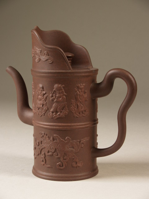 4. Teapot in the form of a mdong-mo ewer, decorated with eight immortals, Yixing, China, c. 19th century, h. 16 cm.; d. 7.5 cm., stoneware, Princessehof National Museum of Ceramics (on loan from Ottema Kingma Foundation), NO 01203. Yixing teapots in such a shape were commonly exported to Europe during the Qing dynasty. Similar teapots are found in the collection of Augustus the Strong (1670-1733) in Dresden. 