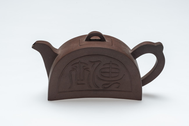 5. Teapot in the shape of a semi-circular eaves tile, Yixing, China, c. 18th to 19th century,