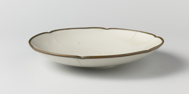 8. Bowl made on a mould with an incised decoration of a lotus plant. Made of glazed stoneware (so-called ding ware) fired upside down on the outer rim, which was then fitted with a metal band. Made in China, c. 960-1279, diameter 19.5 cm, Rijksmuseum Amsterdam (on loan from the Royal Asian Art Society of the Netherlands) AK-MAK-1272